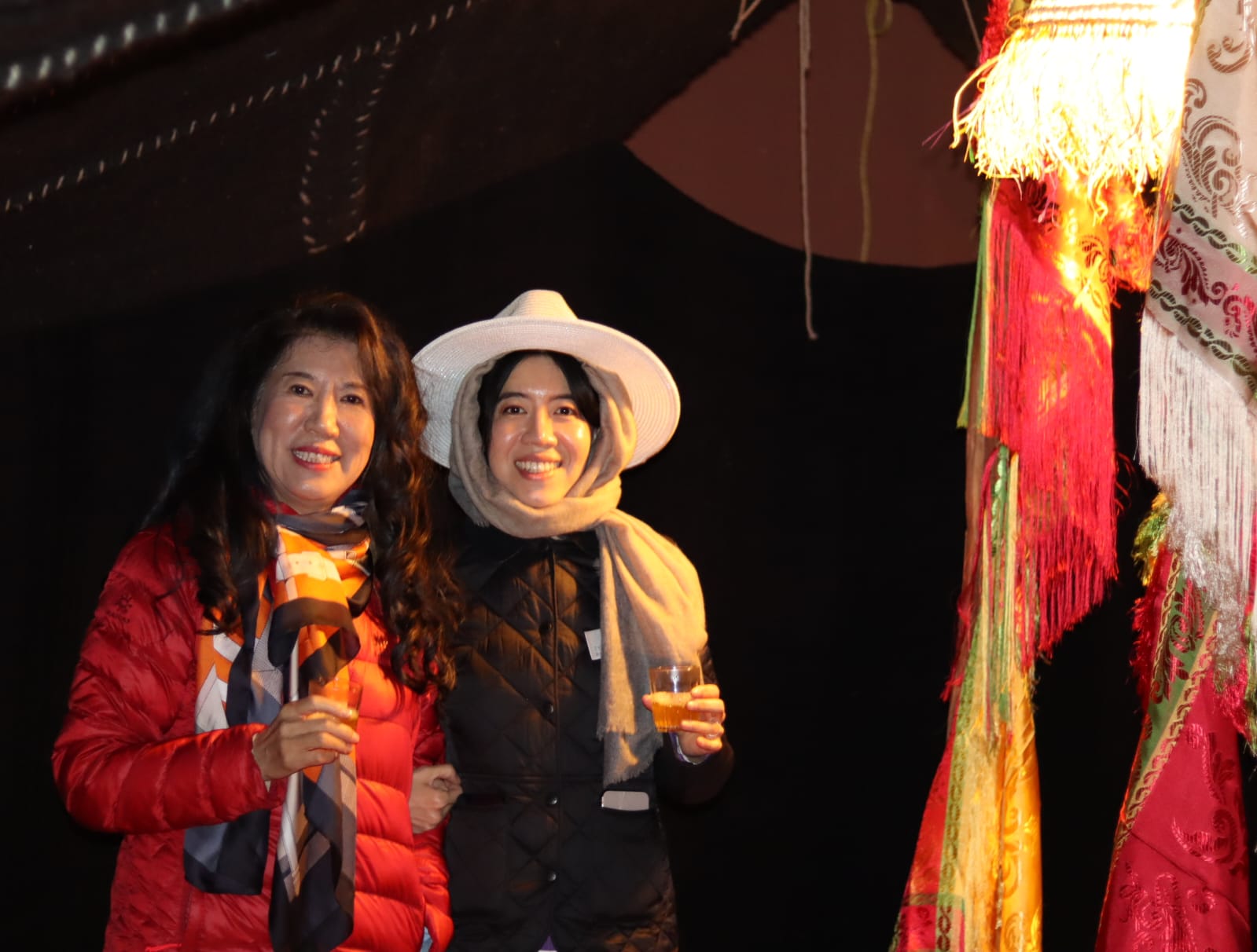 Customer Enjoying Tea Under Nomad Tent at Oasis Balloon Welcome Site.