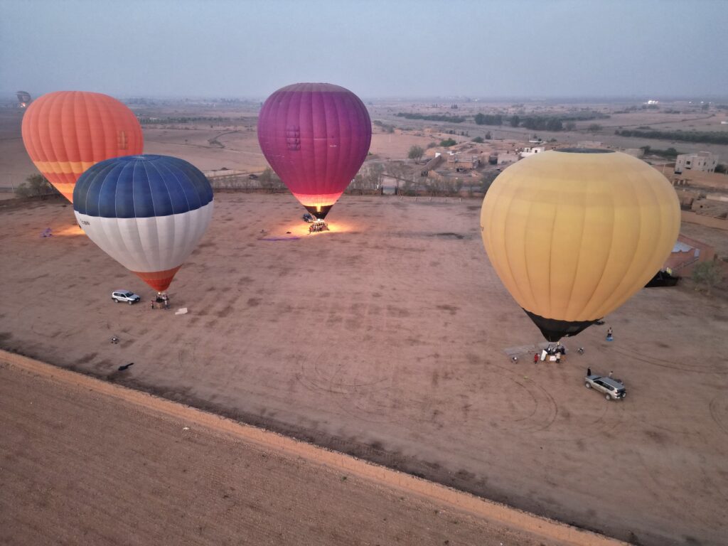 Four hot air balloons taking off from the takeoff zone.