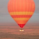 Color Harmony: Tonal Hot Air Balloon Blending with the Moroccan Terrain