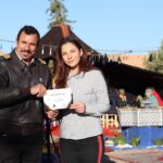 Oasis Balloon Pilot Presenting Flight Certificate to a Passenger.