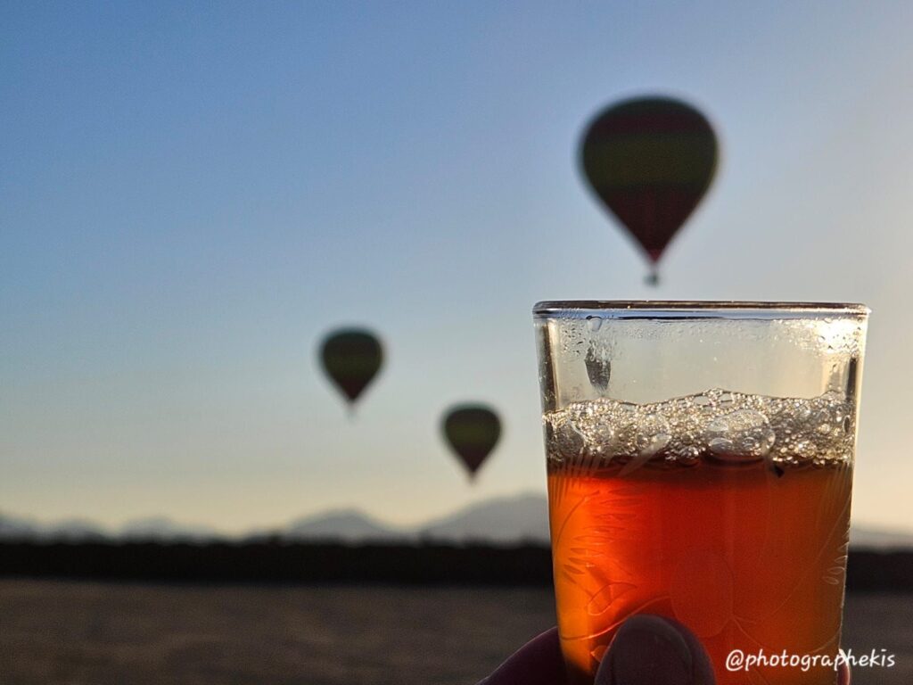 Tranquil Heights: Hot Air Balloon Over a Teatime Landscape